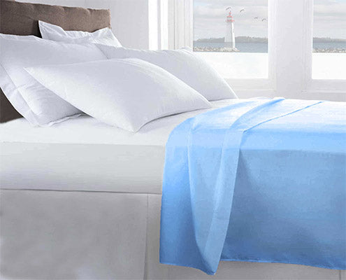 life style image of light blue fitted sheet on the top of the bed with luxury pillows