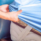 person holding the fitted sheet fitting it on the mattress