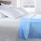 life style image of light blue fitted sheet on the top of the bed with luxury pillows